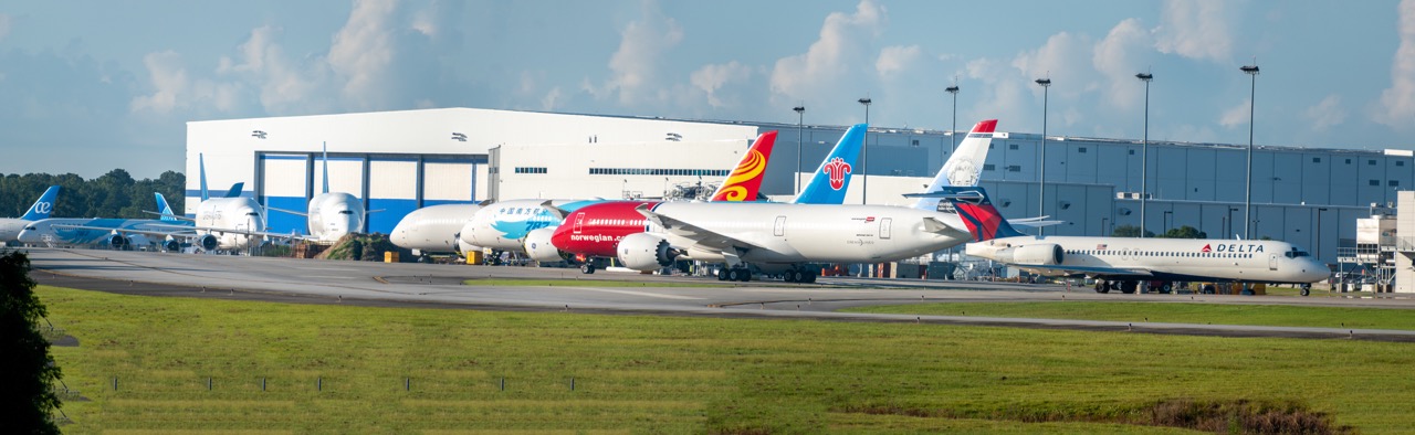 A Boeing 717 parked in front of three brand new 787 Dreamliners made at the Charleston production facility